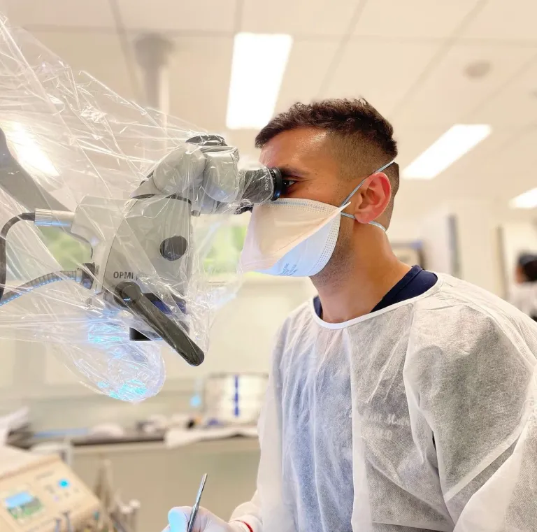 Dr. Malhan performing endodontic treatment under a dental operating microscope